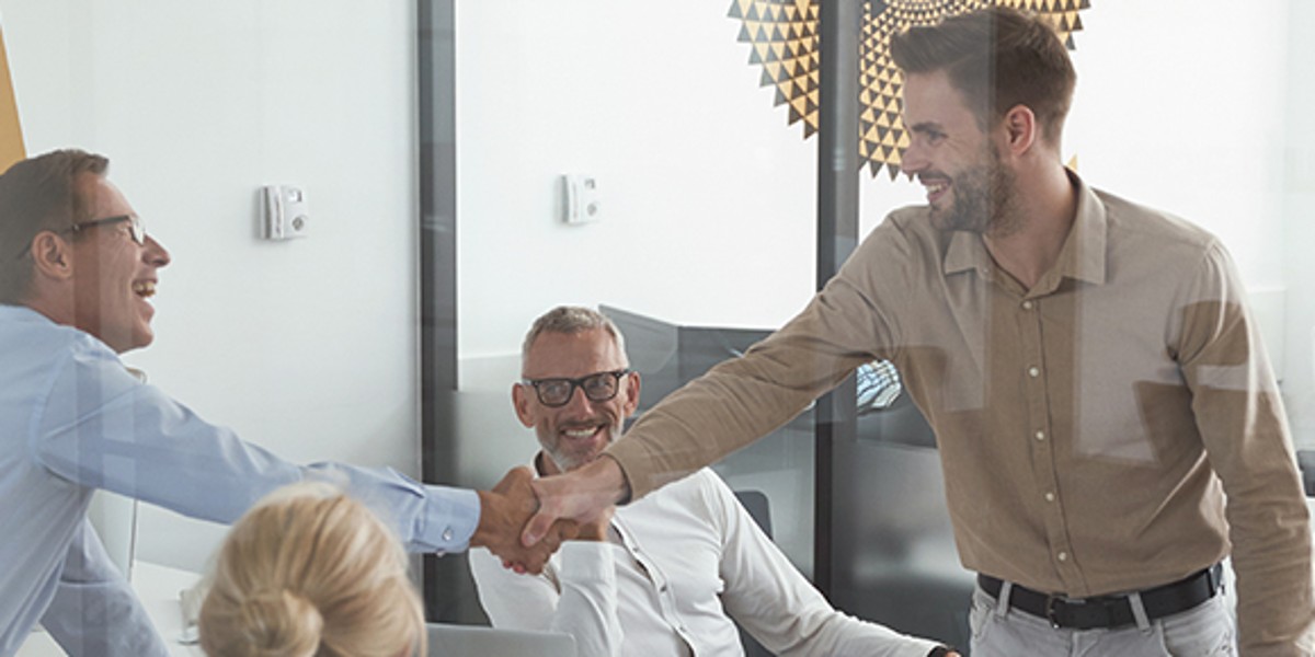 Kompetenz Mitarbeiter geben sich die Hand